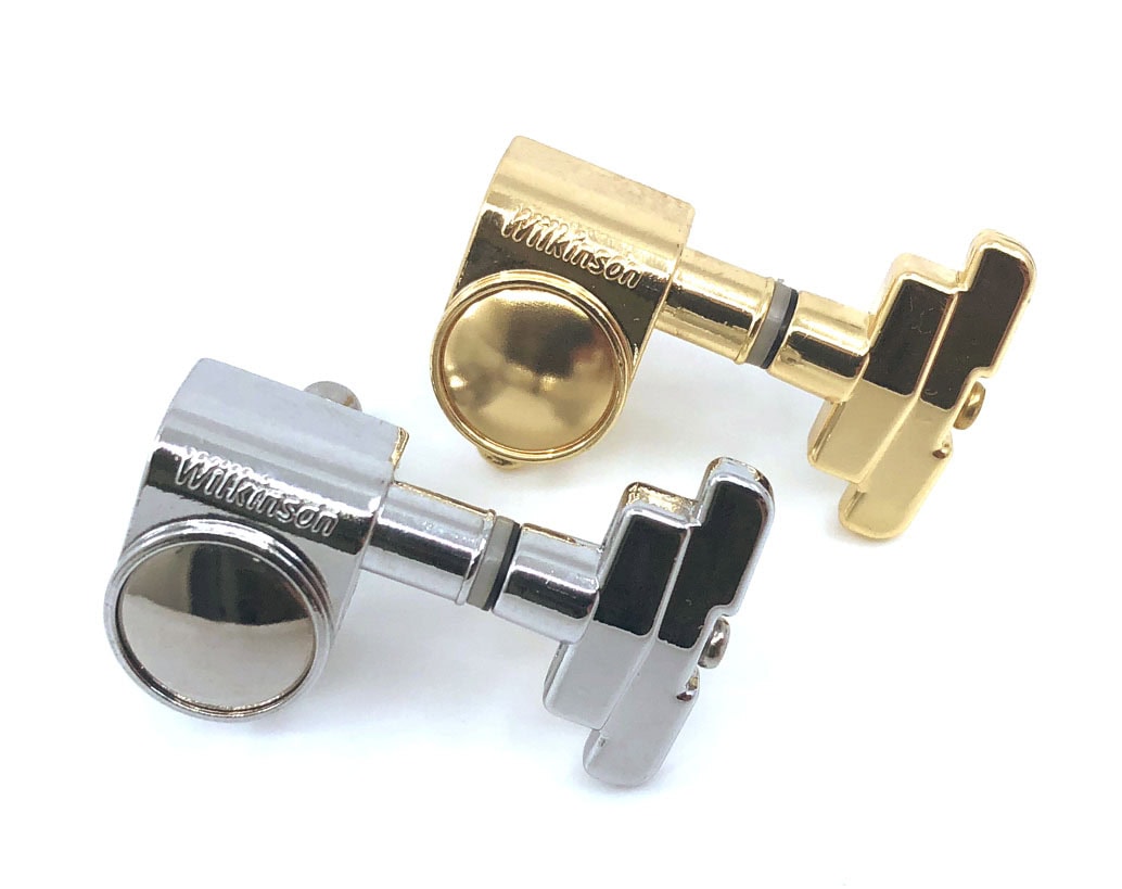 Two guitar tuning machine heads in gold and silver finishes with Wilkinson branding.