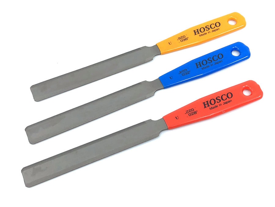 Three double edge metal files with orange, blue, and red handles labeled HOSCO and size markings.