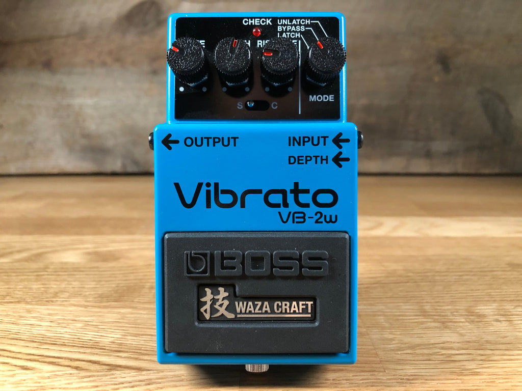 Blue guitar effects pedal with four knobs, two input/output jacks, and Waza Craft branding on footswitch.