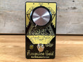Black and gold guitar effects pedal with one large knob, footswitch, and LED indicator.