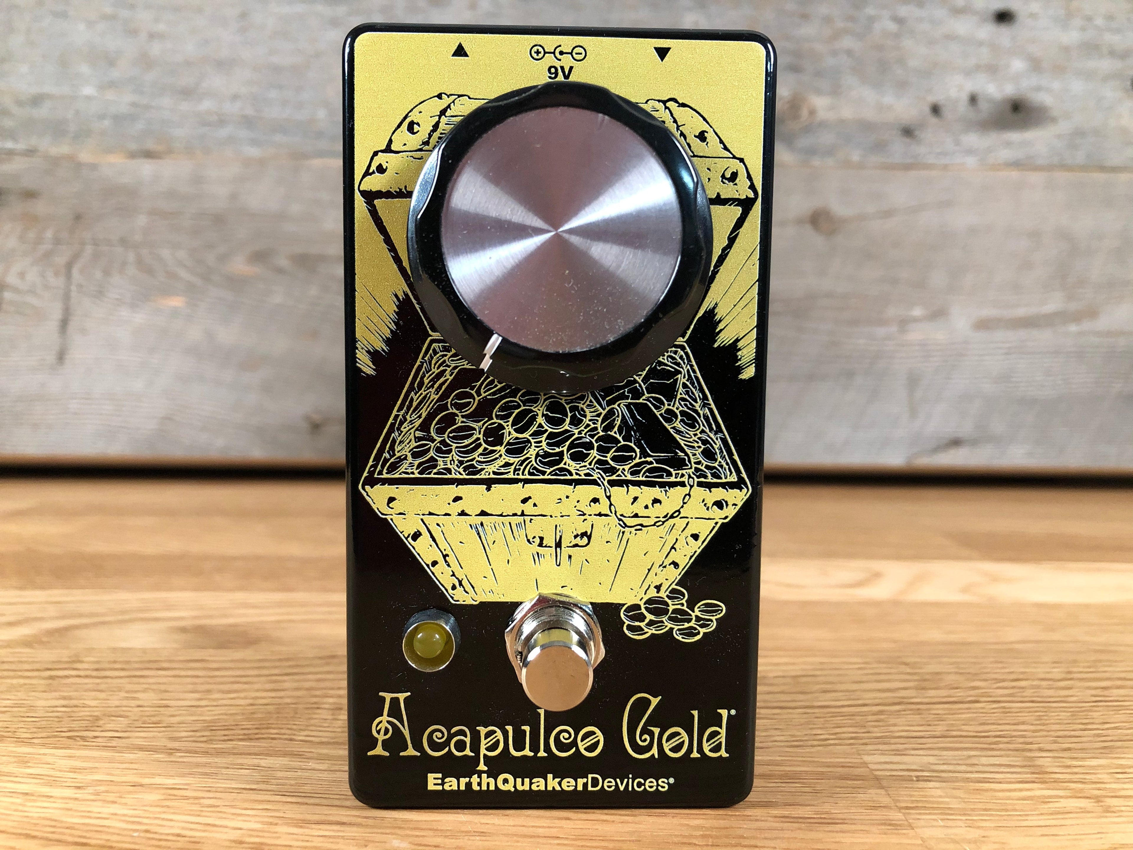 Black and gold guitar effects pedal with one large knob, footswitch, and LED indicator.