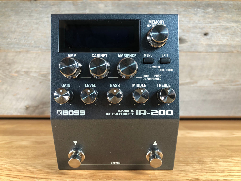 Black Boss IR-200 guitar effects pedal with multiple knobs, buttons, and two footswitches on wood surface.