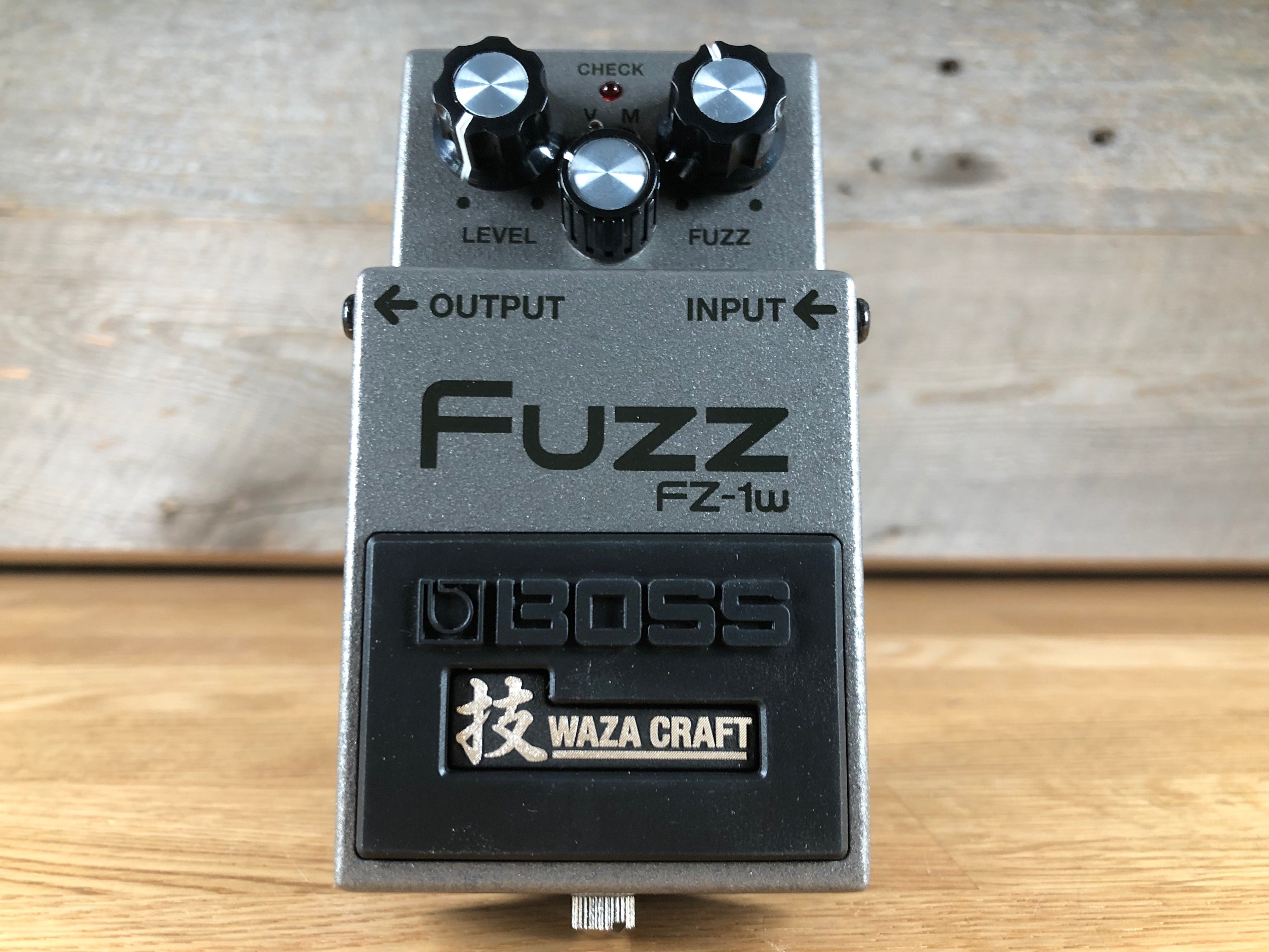 Gray and black Boss Fuzz FZ-1W guitar effects pedal with three control knobs and input/output jacks.