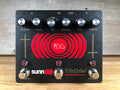 Black guitar effects pedal with six knobs, three footswitches, red LED indicators, and red circular graphic with white text.