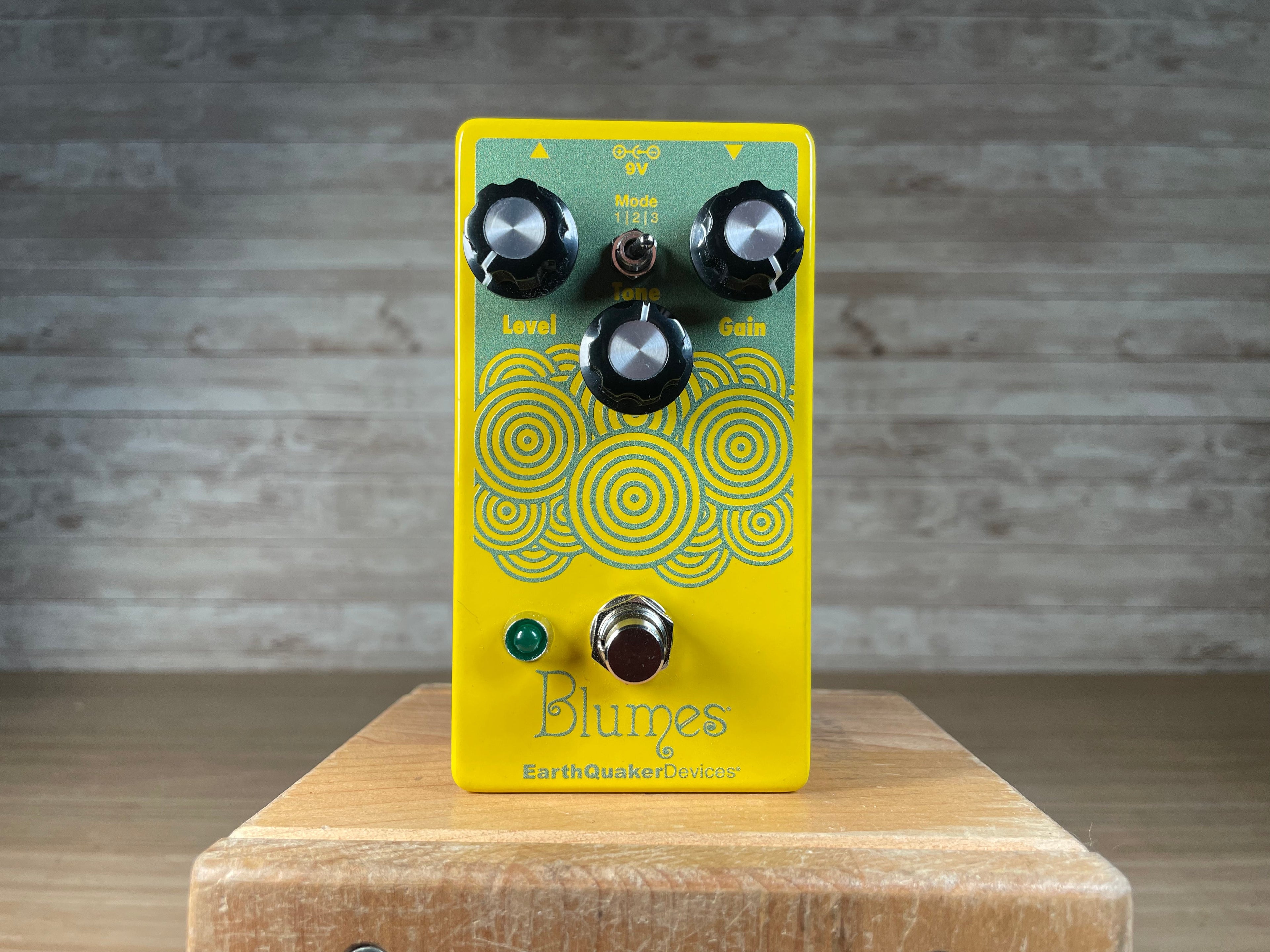 Yellow pedal with three knobs, a toggle switch, and footswitch showing 'Blumes' and 'EarthQuaker Devices' text.