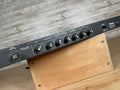 Black Ibanez DM500 digital delay rack unit with multiple control knobs and power switch on a wooden angled stand.