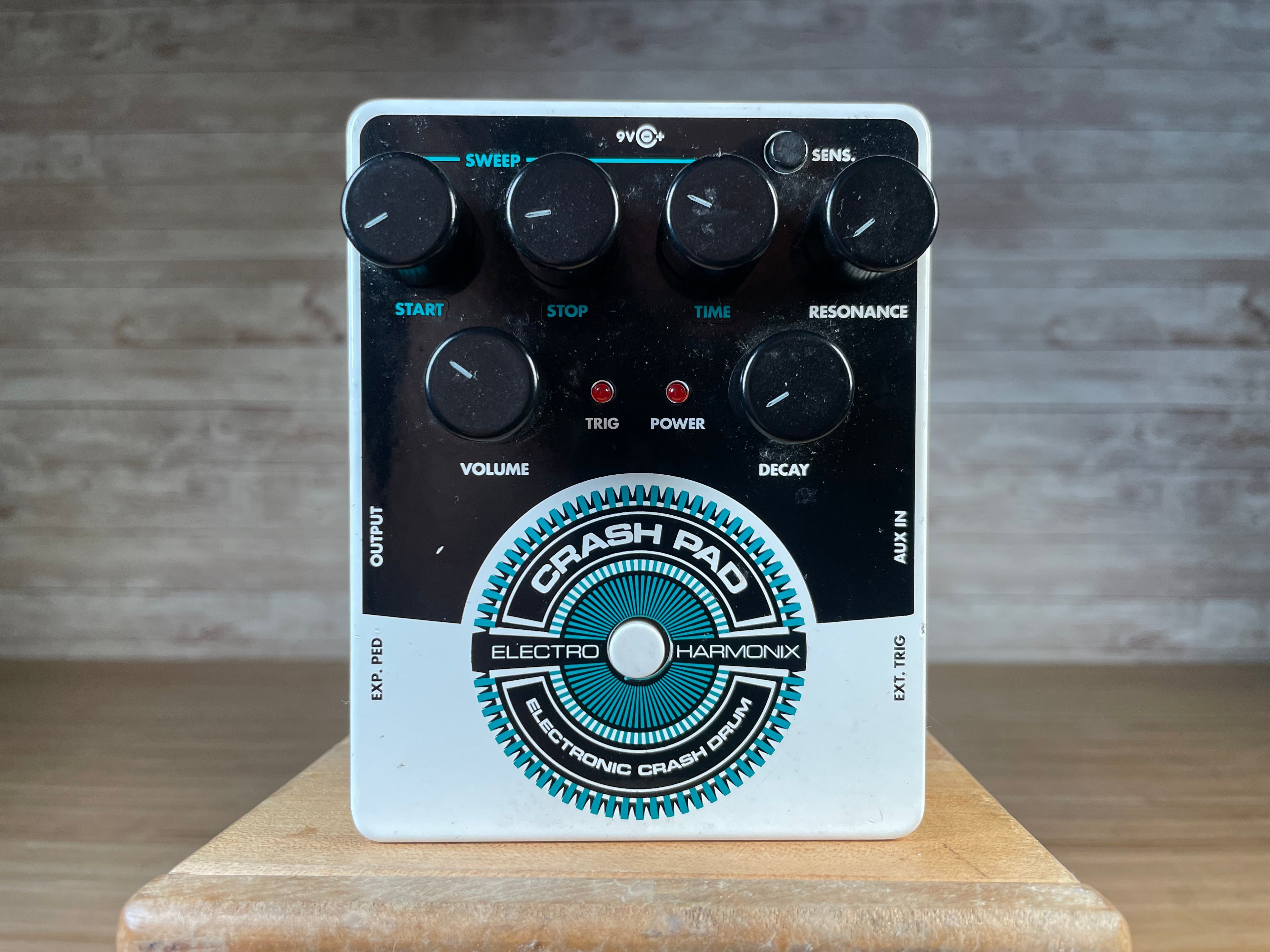 Front view of an Electro-Harmonix Crash Pad electronic drum pedal with knobs and input/output jacks.