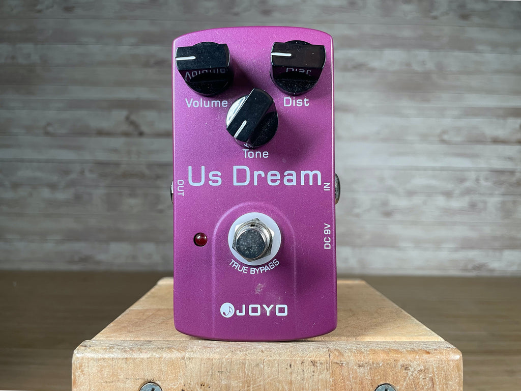 Purple guitar pedal labeled Us Dream with three control knobs, a footswitch, and input/output jacks.