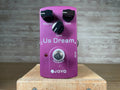Purple guitar pedal labeled Us Dream with three control knobs, a footswitch, and input/output jacks.