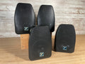 Four black Yorkville speakers with front mesh grills arranged on a wooden surface and wood stand.