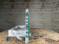 Eurorack module with six jack sockets and a ribbon cable connected, standing next to a cardboard box labeled Unity Mixer MIX-3U.