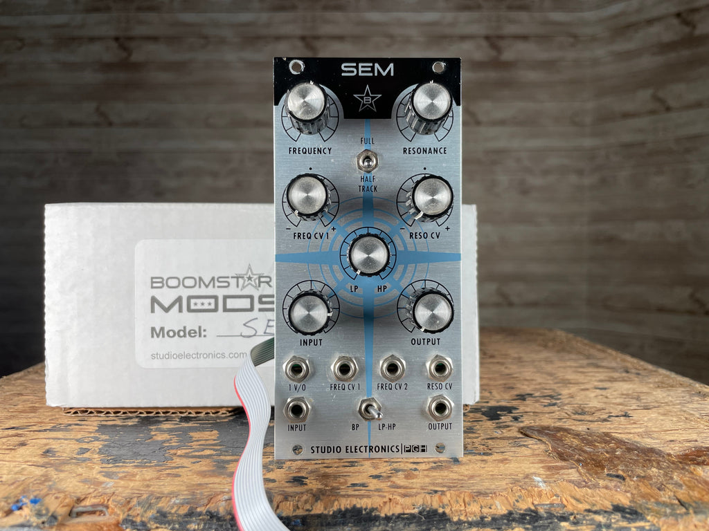 Studio Electronics SEM filter eurorack module with knobs, switches, jacks, cable, and original Boomstar Mods box.