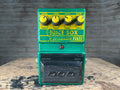 Green and yellow DOD guitar effects pedal with four knobs and a footswitch on a wooden surface.