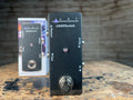Black ART LOOPSwitch pedal with footswitch and original box on a wooden surface.