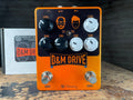 Orange guitar effects pedal with black and white knobs labeled D&M Drive and two footswitches marked Drive and Boost.