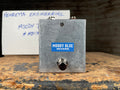 Rectangular metal guitar effects pedal labeled Moody Blue Reverb with a footswitch and two 1/4 inch jacks on top.