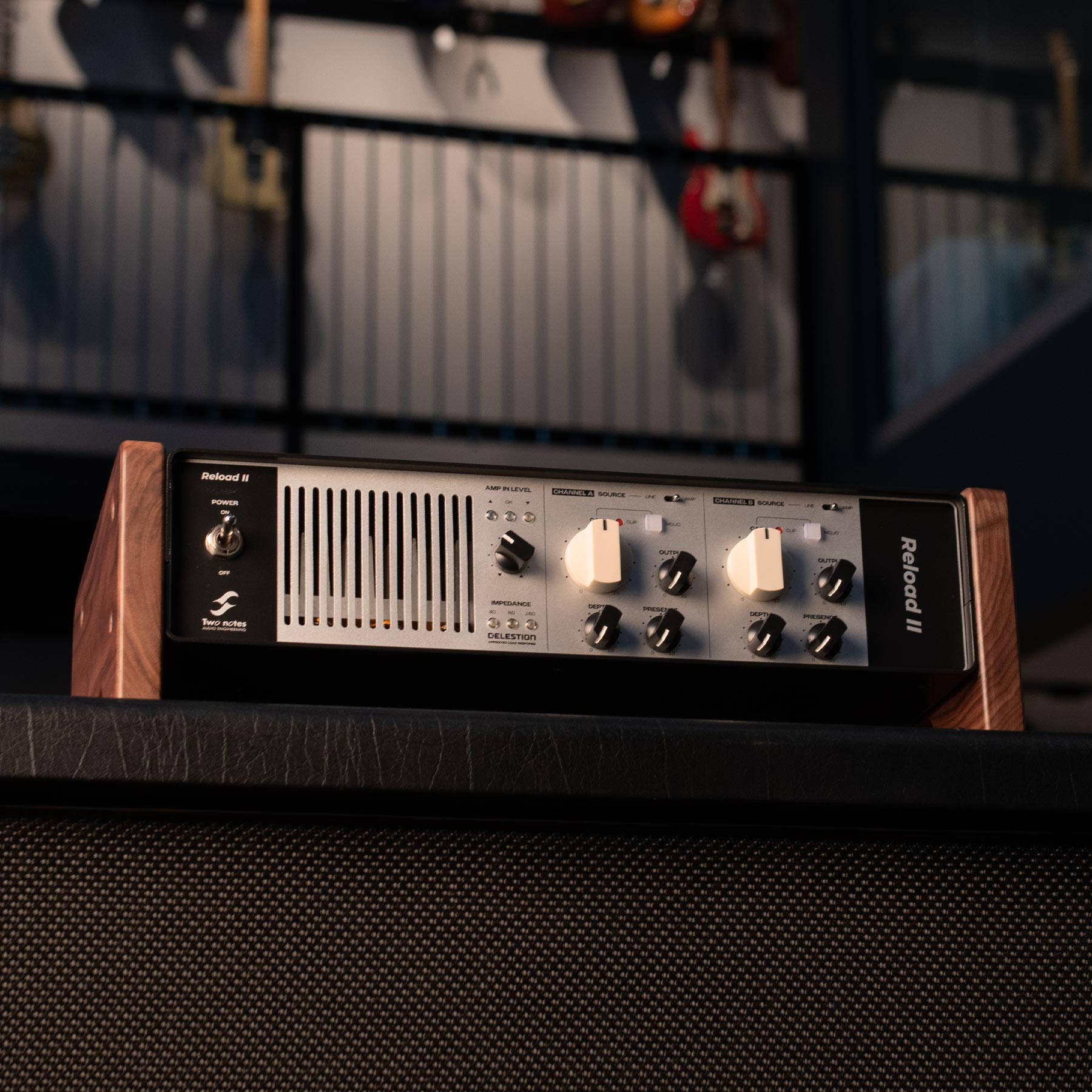 Two Notes Reload II audio device with wooden side panels and multiple rotary knobs and switches on the front panel.