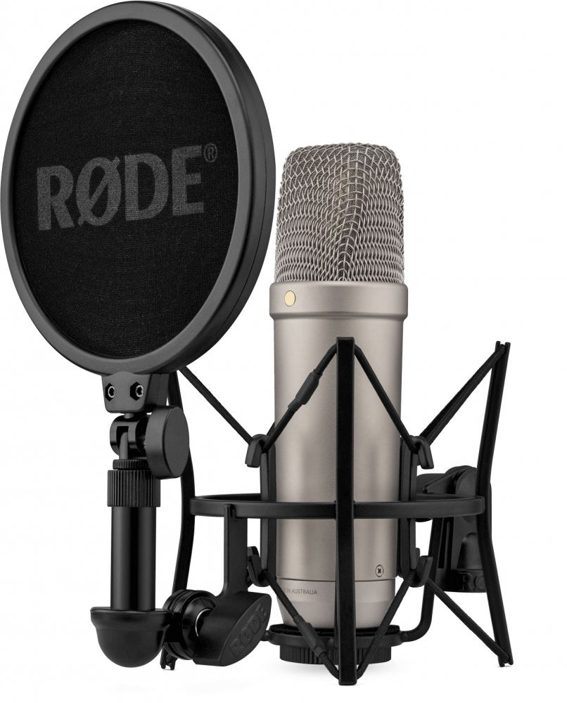 Silver condenser microphone in black shock mount with black pop filter showing RØDE logo.