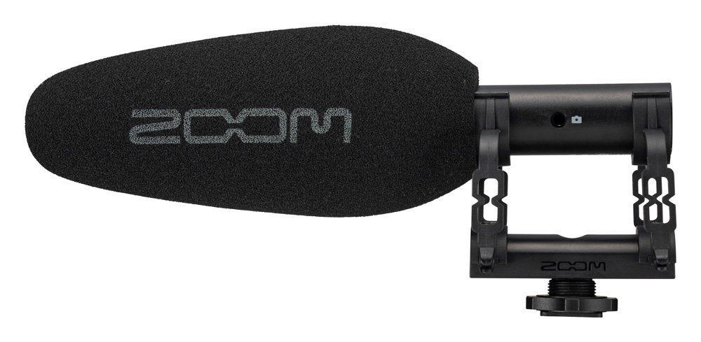 Black shotgun microphone with foam windscreen and mounting bracket showing the Zoom logo