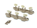 Two silver guitar tuning peg plates with white oval tuning keys and a small pile of screws on a white background.