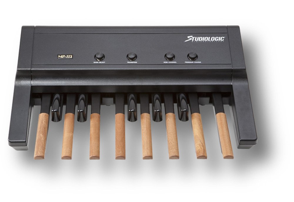 Black MIDI controller with eight wooden keys and four black control knobs labeled above.