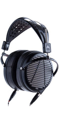 Black over-ear headphones with perforated leather headband and dual mini XLR audio connectors.