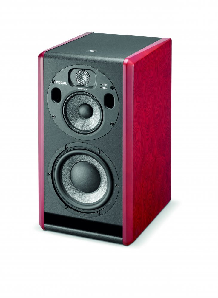 Studio monitor speaker with red wood sides and black front with three speaker drivers and indicators.