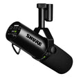 Black Shure microphone with foam windscreen and adjustable mounting bracket with switches visible on rear panel.