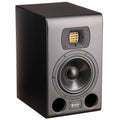 Black studio monitor speaker with a yellow tweeter, mid-range driver, and dual bass ports on the front panel.