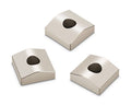 Three silver metallic square-shaped blocks with a hole in the center of each.