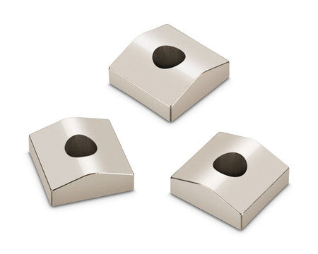 Three silver metallic square-shaped blocks with a hole in the center of each.