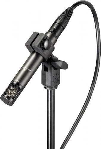 Black and silver Audio-Technica ATM450 microphone mounted on a stand with attached cable.