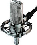Silver studio condenser microphone attached to a black shock mount with an XLR cable connected.