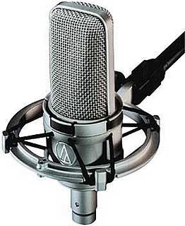 Silver studio condenser microphone attached to a black shock mount with an XLR cable connected.