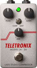 Silver guitar effects pedal with three black knobs, a toggle switch, LED light, and a footswitch labeled Teletronix Model LA-2A.