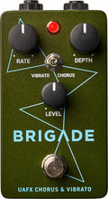 Olive green guitar pedal with three knobs, a toggle switch, a red LED, and a footswitch labeled Brigade UAFX Chorus & Vibrato.
