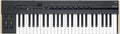 Black and beige MIDI keyboard controller with 49 keys, multiple knobs, buttons, and two modulation wheels on the left.