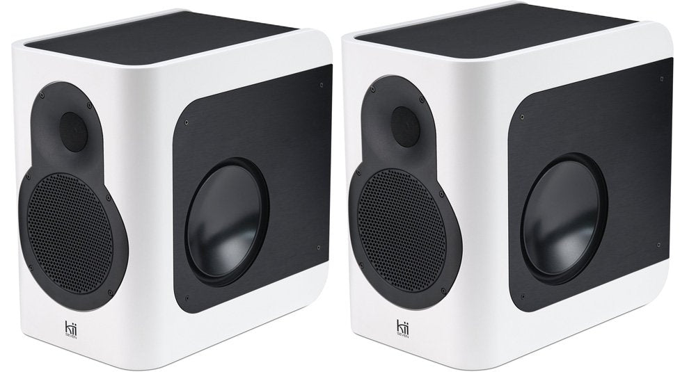 Pair of white and black speakers with front and side drivers, branded with 'kii' logo on front.