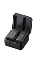 Two black Sony devices with buttons inside an open black charging case.
