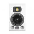 White studio monitor speaker with black woofer, yellow tweeter, and dual front ports.