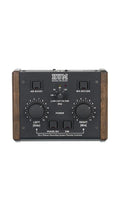 Black audio device with wooden side panels featuring knobs and buttons for air boost, M/S decode, and low cut filter controls.
