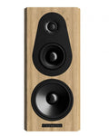 Front view of a wooden-finish speaker with three drivers and a Bryston logo plaque.