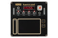 Top view of a black KORG Kaoss Pad with buttons, LED display, touchpad, and pin headers visible.