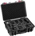 Open black hard case containing a handheld microphone, two wireless microphone units, and mounting clips in protective foam.