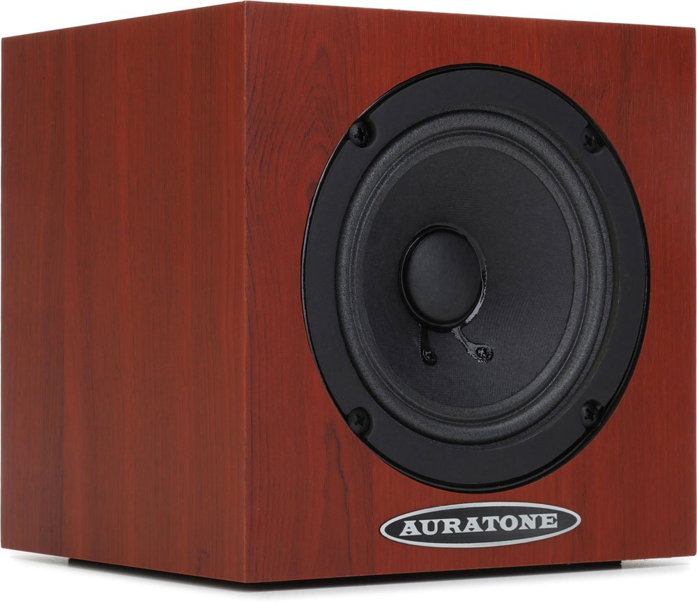 Cube-shaped speaker with reddish wood grain finish and black round driver on front with Auratone logo below.