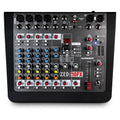 Top view of a black audio mixer with multiple input connectors, knobs, sliders, and digital display.