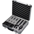 Set of multiple black microphones with clips and cables in a silver aluminum carrying case with foam padding.