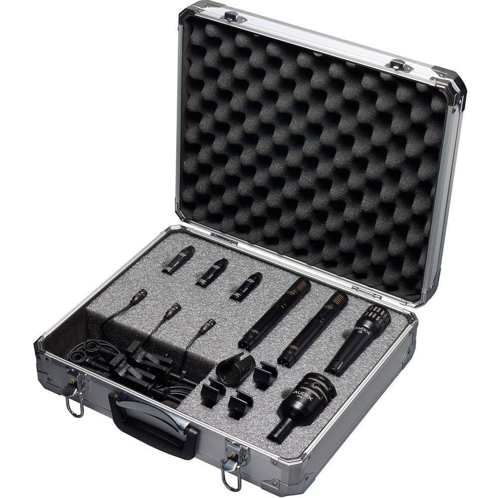 Set of multiple black microphones with clips and cables in a silver aluminum carrying case with foam padding.