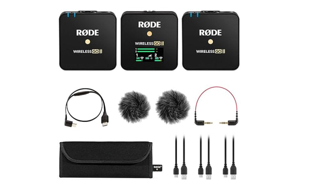 Three black RØDE Wireless GO II units with accessories including cables, furry windshields, and carrying pouch displayed on a white background.
