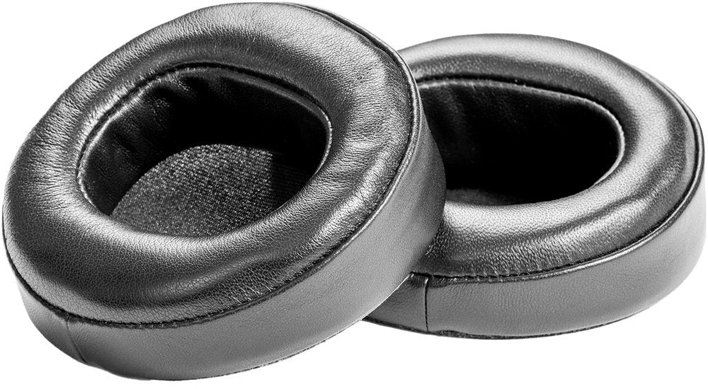 Pair of black circular headphone earpads with leather-like outer surface and fabric inner lining.